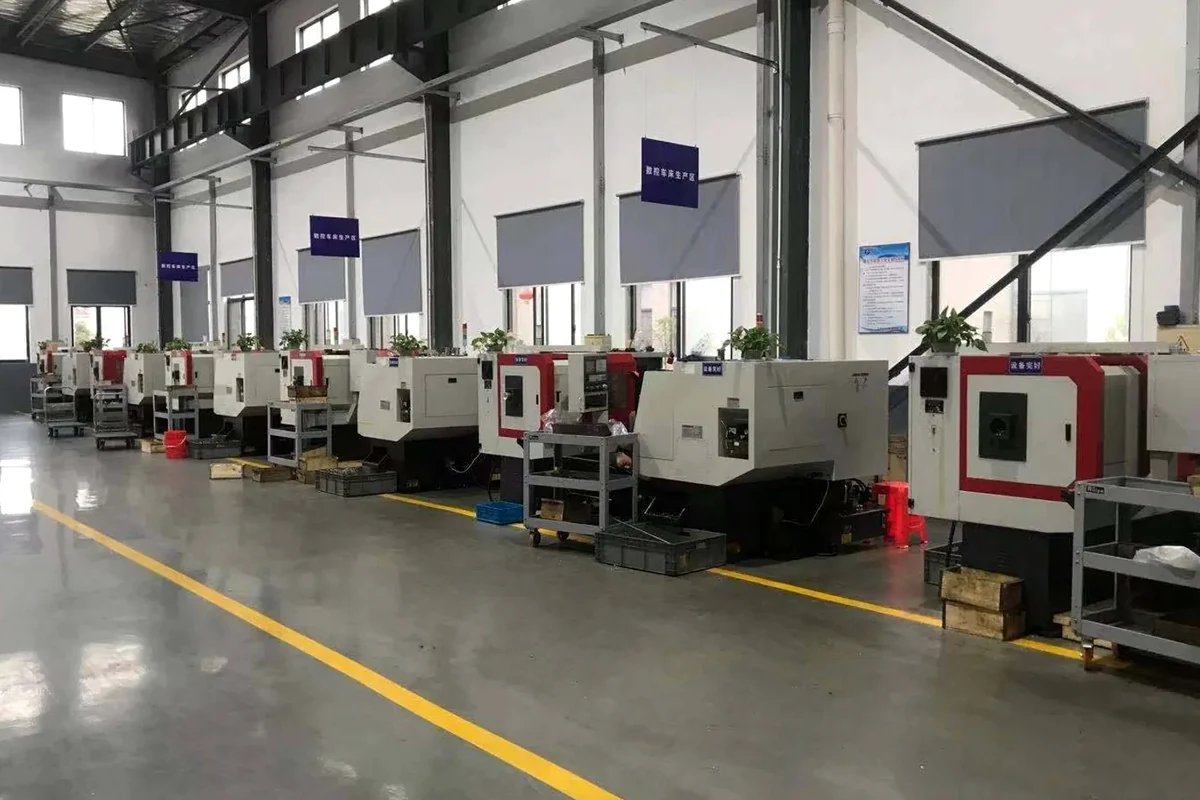 Rows of enclosed CNC machines.