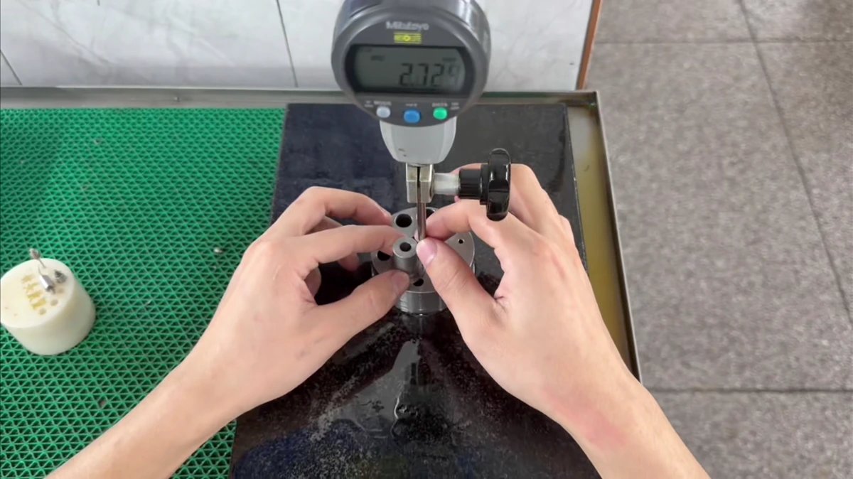 An operator checking a component with a digital instrument.