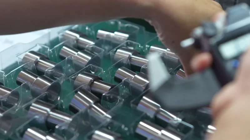 A group of precision turned metal components being checked