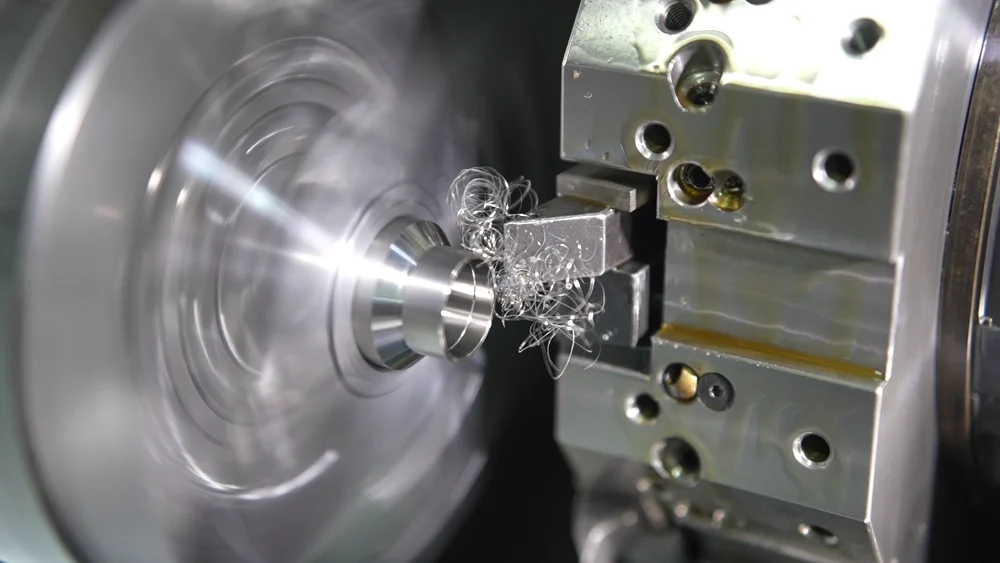 Cutting tool machining the diameter of a rotating metal workpiece