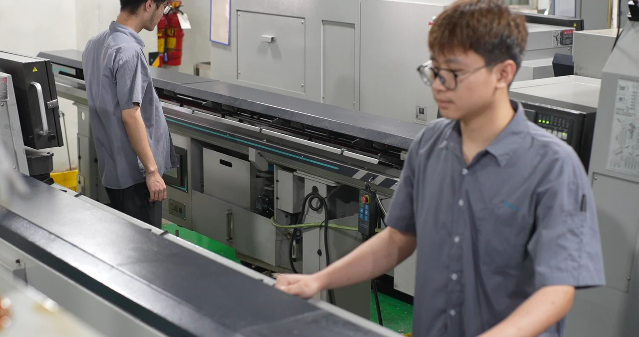 Operator working at a CNC bar-feed line