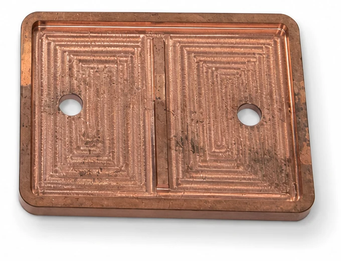 Real copper plate component with machined flow channels, mating perimeter and two openings